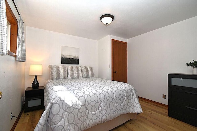 bedroom with wood finished floors