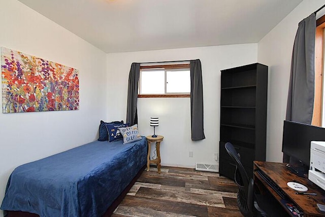 bedroom with visible vents and wood finished floors