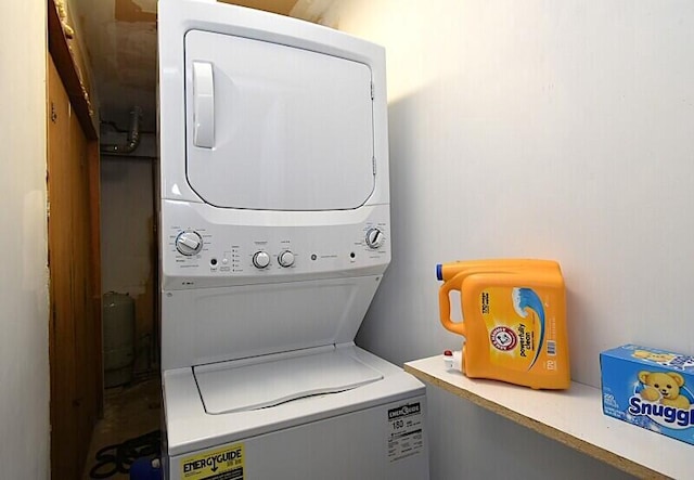 laundry area featuring stacked washer / drying machine