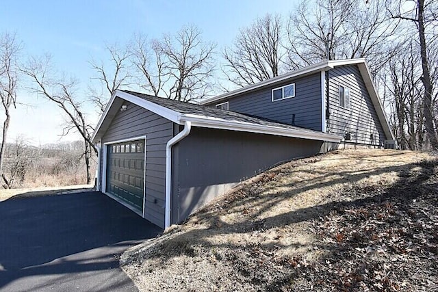 view of side of property with a detached garage