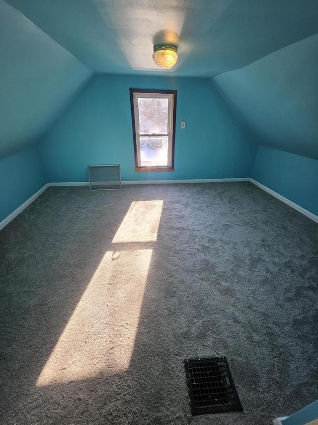 bonus room featuring visible vents, lofted ceiling, baseboards, and carpet flooring