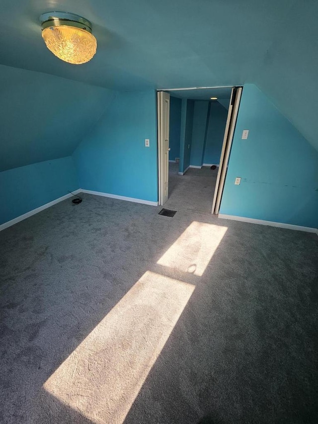 bonus room with lofted ceiling, carpet, and baseboards