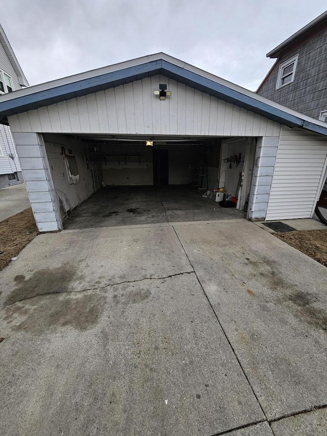 garage featuring concrete driveway