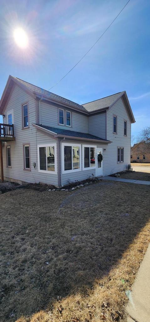 rear view of property featuring a yard