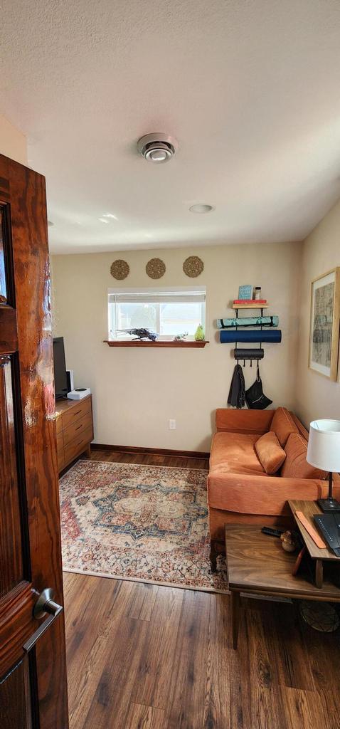 living room with wood finished floors and visible vents