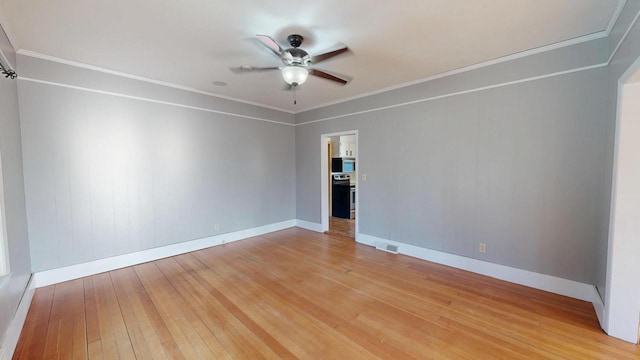 unfurnished room with crown molding, baseboards, light wood-style floors, and ceiling fan