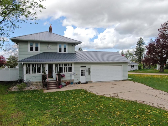 view of front facade with driveway, a front yard, an attached garage, metal roof, and a chimney