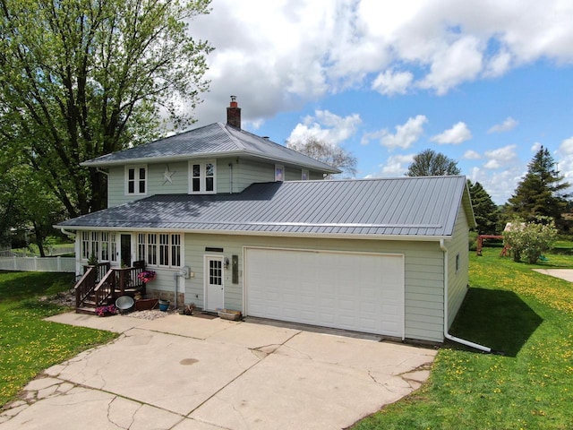 view of front of property featuring a front lawn, a garage, driveway, and a chimney