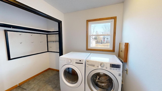 laundry room featuring washer and dryer, laundry area, baseboards, and a textured ceiling