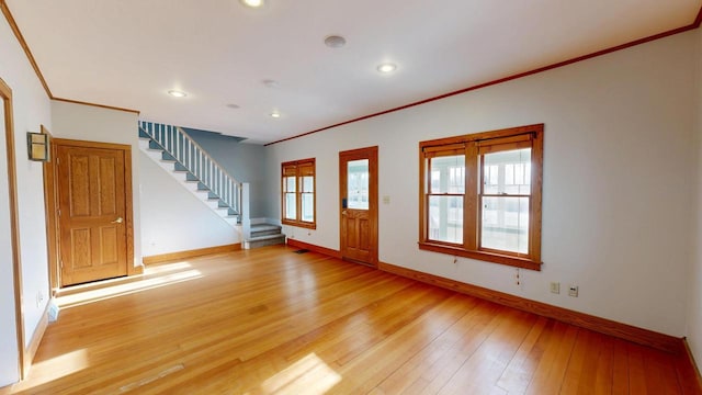 foyer featuring recessed lighting, stairway, crown molding, light wood finished floors, and baseboards