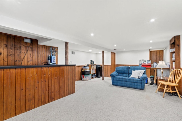 interior space featuring recessed lighting, bar, wood walls, wainscoting, and carpet flooring