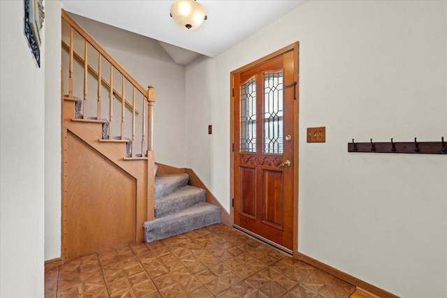 entryway with stairs and baseboards