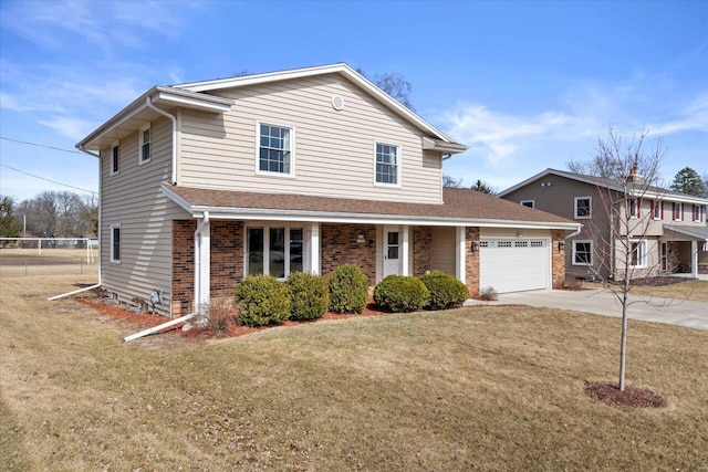 traditional home featuring fence, concrete driveway, a front yard, a garage, and brick siding