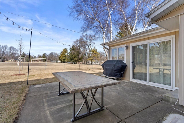 view of patio / terrace with area for grilling and fence