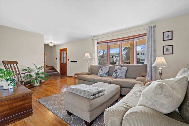 living area with stairway and light wood-style flooring