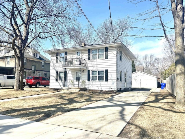 view of front of home featuring a balcony, fence, an outdoor structure, concrete driveway, and a garage