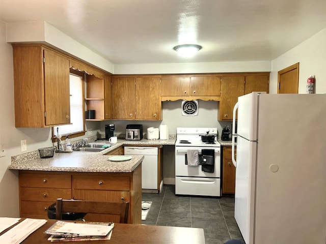 kitchen with brown cabinetry, visible vents, white appliances, and a sink