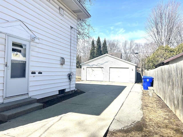 view of side of property with a garage, fence, an outdoor structure, and entry steps