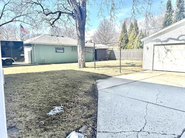 view of yard with an outbuilding and fence