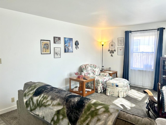 carpeted living area featuring baseboards