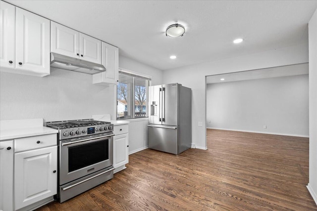 kitchen with under cabinet range hood, dark wood-style floors, white cabinetry, and stainless steel appliances