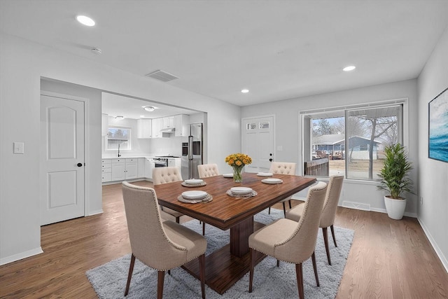 dining room featuring recessed lighting, visible vents, baseboards, and wood finished floors