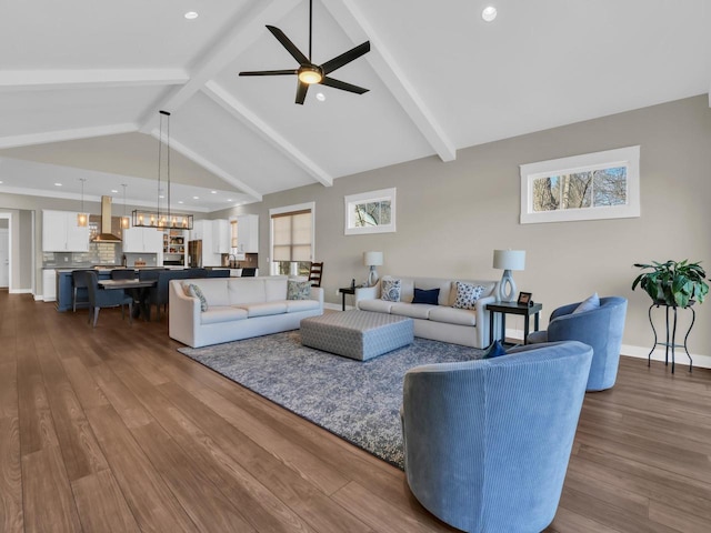 living room featuring dark wood-style floors, beamed ceiling, and a ceiling fan