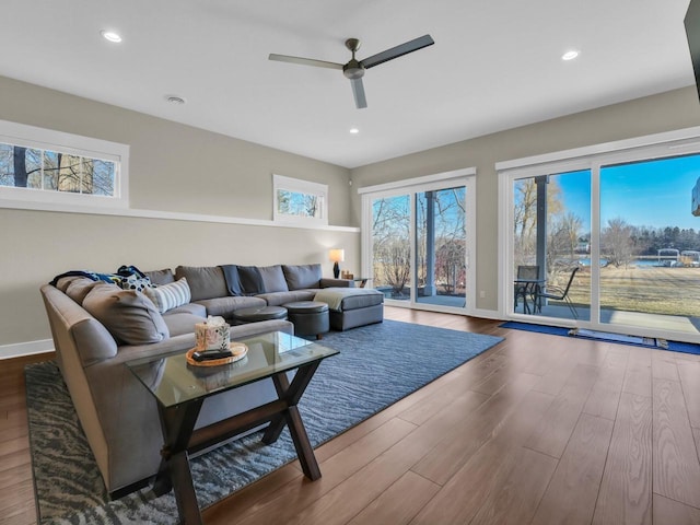 living area with recessed lighting, wood finished floors, and a ceiling fan