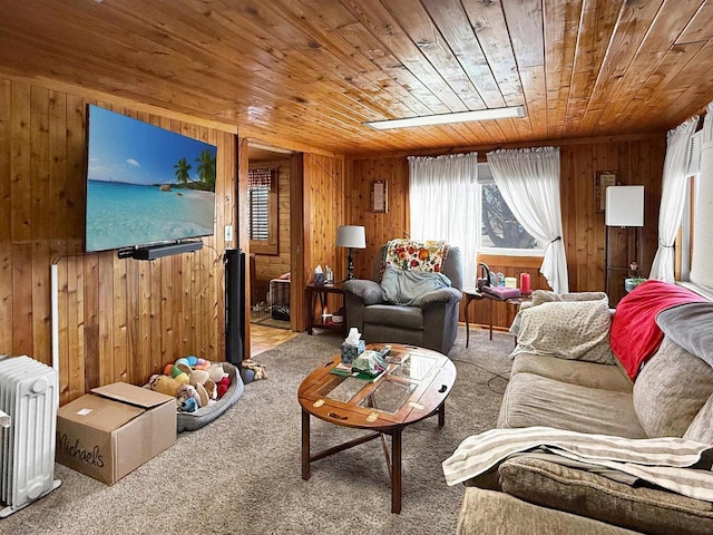 living area featuring wooden ceiling, radiator, carpet, and wood walls