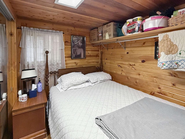 bedroom with wood walls and wooden ceiling