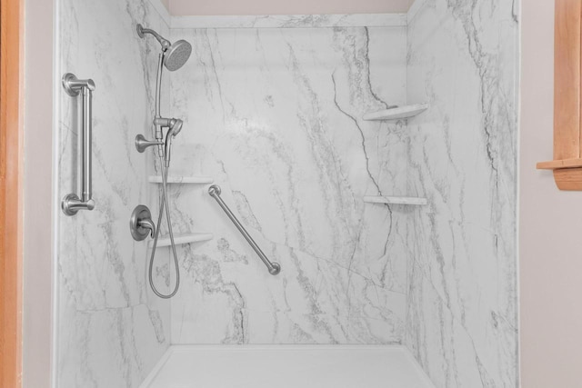 full bath with a marble finish shower