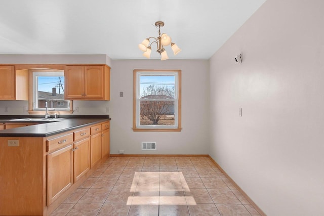 kitchen with a chandelier, visible vents, a healthy amount of sunlight, and a sink