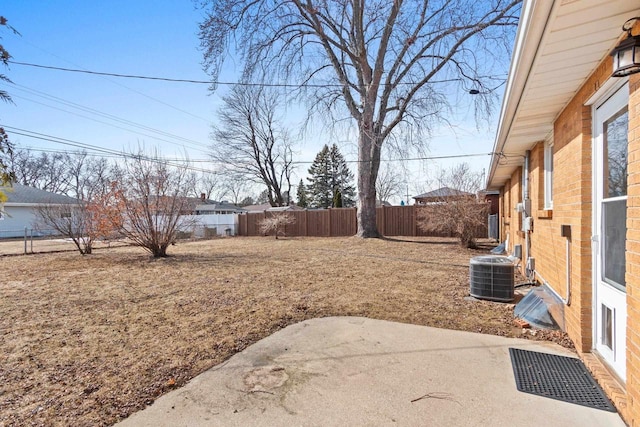 view of yard with a patio, central AC unit, and a fenced backyard