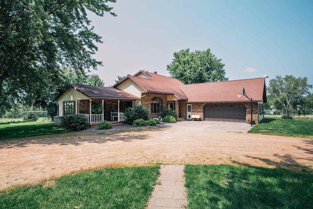 ranch-style house with brick siding, a garage, a front lawn, and driveway