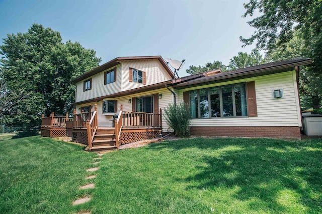 rear view of property featuring a yard and a wooden deck