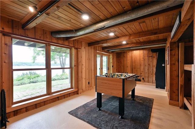 rec room featuring wooden walls, beamed ceiling, and wooden ceiling