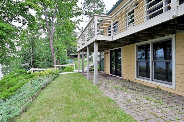 view of yard with stairway, a deck, and a patio area