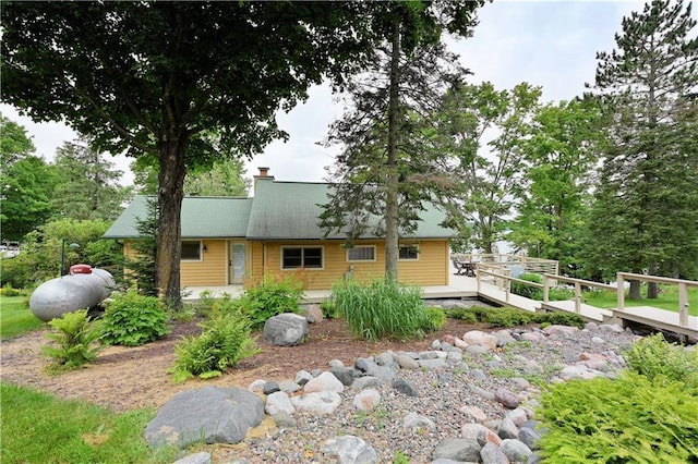 exterior space featuring a deck and a chimney