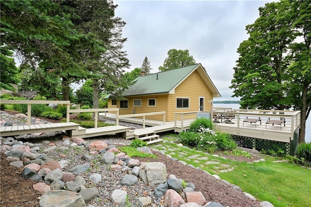 back of property with a deck and a chimney