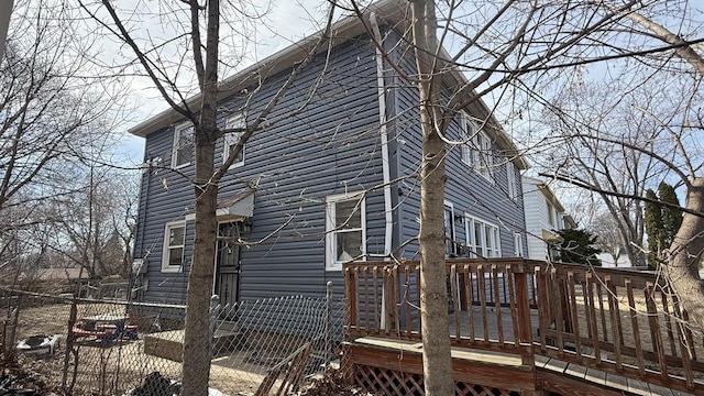 view of home's exterior featuring a wooden deck and fence