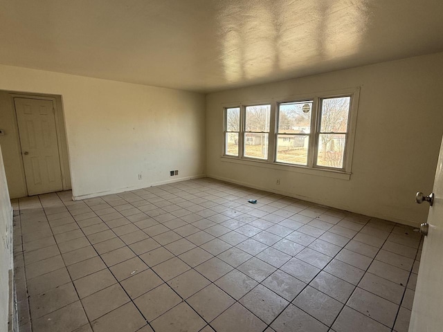 spare room with light tile patterned floors and visible vents