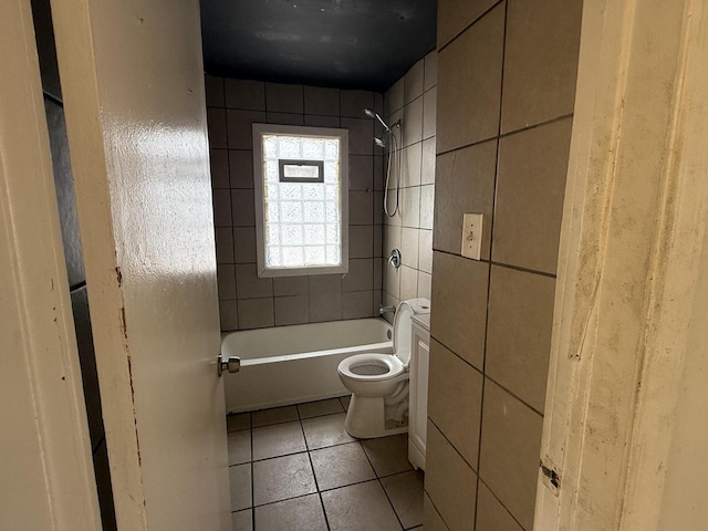 full bath featuring tile patterned floors, toilet, tile walls, and bathtub / shower combination