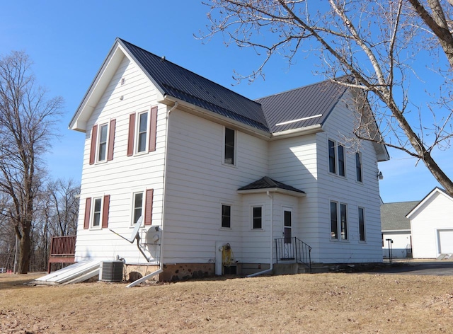 view of front facade with metal roof and central air condition unit