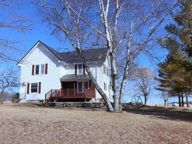 back of house featuring a wooden deck