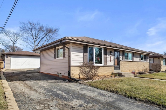 single story home with a detached garage, brick siding, an outdoor structure, and a front lawn