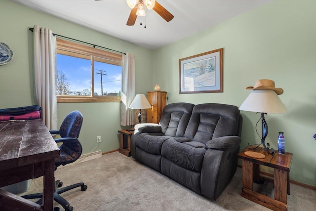 office area with baseboard heating, a ceiling fan, baseboards, and carpet floors