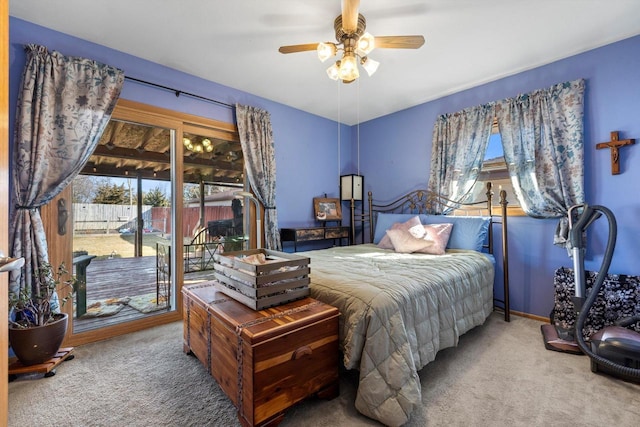 bedroom featuring ceiling fan, baseboards, carpet floors, and access to exterior