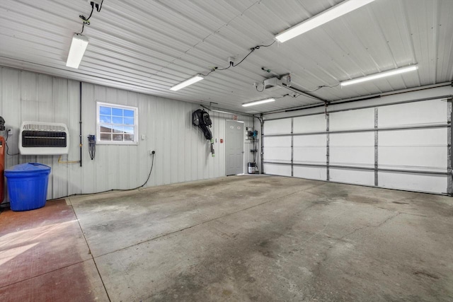 garage featuring heating unit and metal wall