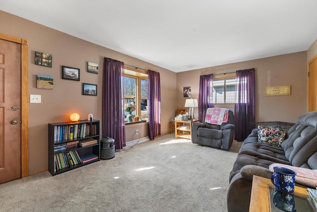 carpeted living area with a healthy amount of sunlight