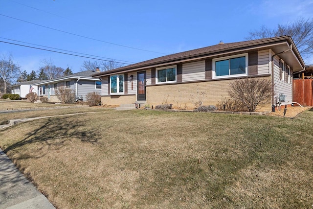 single story home with brick siding and a front yard